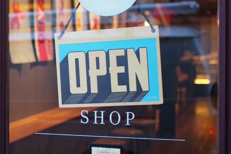 “open” sign on a shop window