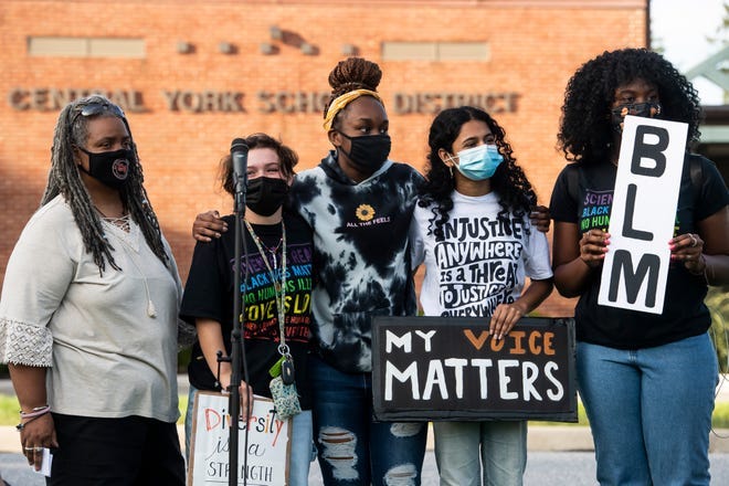Central York High School teacher Patricia Jackson, from left, joins students Olivia Pituch, Renee Ellis, Edha Gupta and Christina Ellis during a protest outside the Central York School District Educational Service Center on Monday, Sept. 20, 2021, in Springettsbury Township.