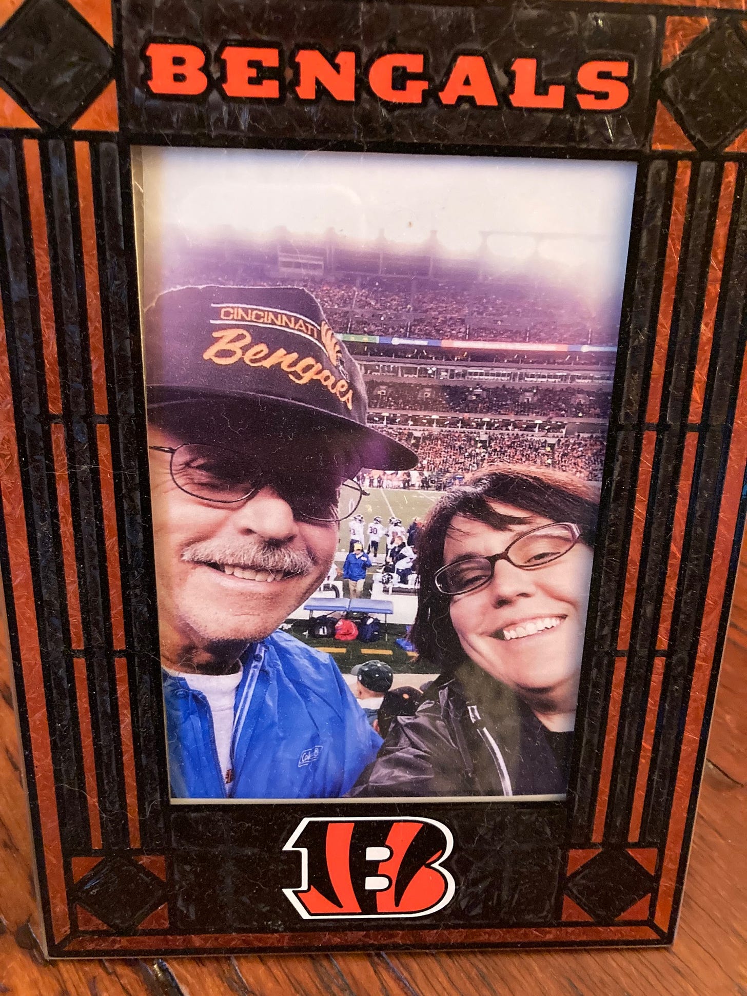 A picture of Robyn and her dad at a Bengals game, in a Bengals frame