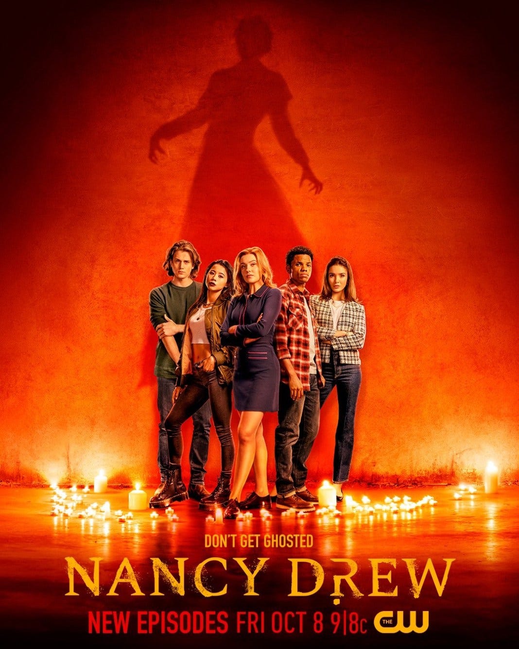 Nancy Drew Season 3 Promo Image: The Drew Crew stands in a candelit circle. A shadowy figure stands behind them as if a puppet master.