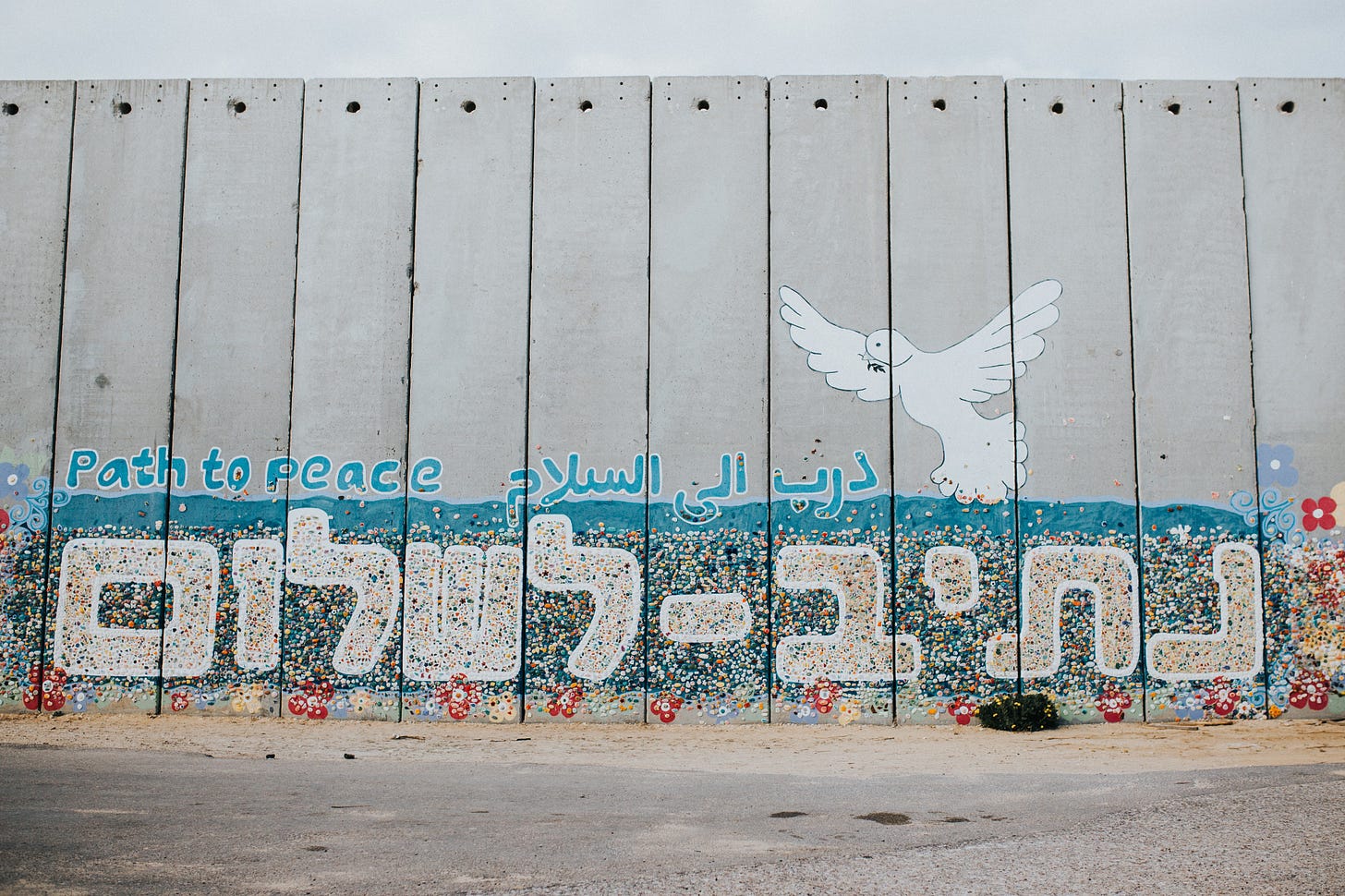 “Path to Peace” wall art painting in English, Arabic, and Hebrew with a dov e— in Netiv HaAsara facing the Gaza border “Path to Peace” wall art painting in English, Arabic, and Hebrew with a dov e— in Netiv HaAsara facing the Gaza border