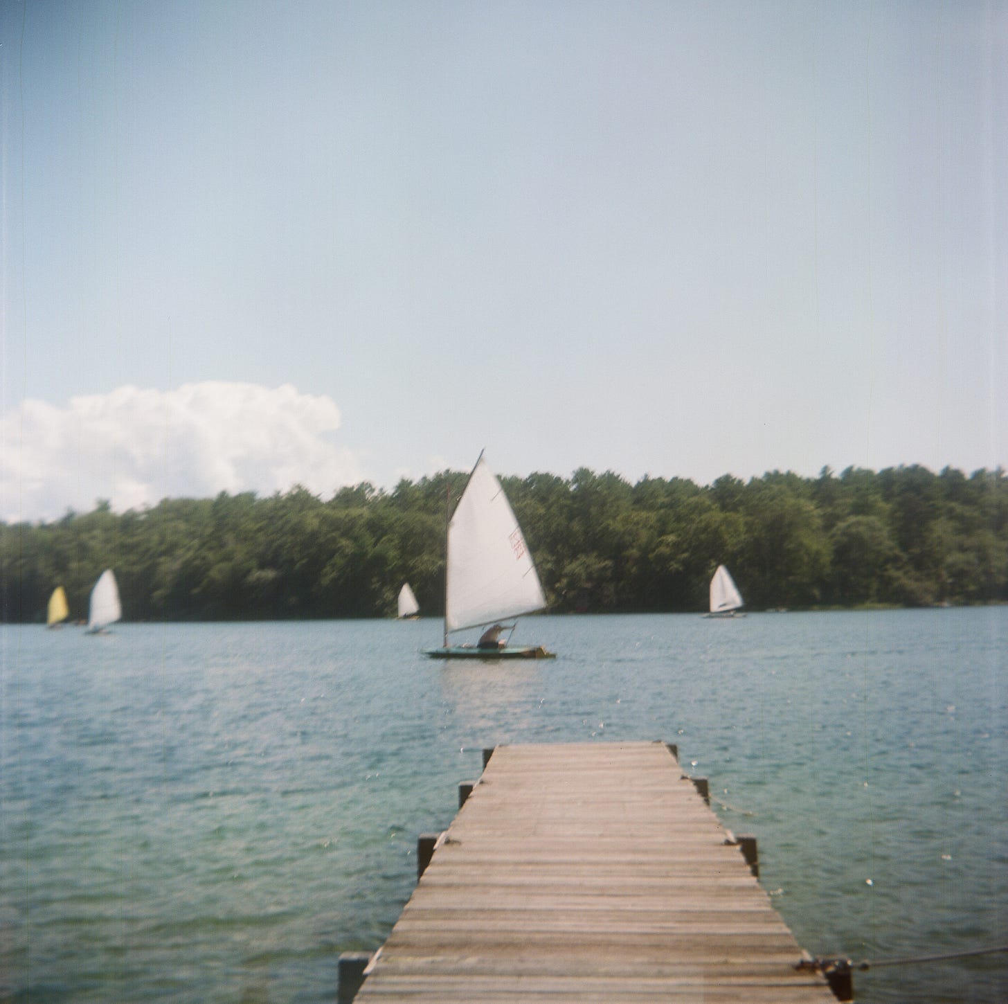 A sailboat on a pond A sailboat on a pond