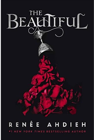 The cover of “The Beautiful” by Renee Ahdieh. The cover of the book is black with the title written in bold, silver letters at the top of the page. Below the title, a silver goblet is spilling over and crimson rose petals are spilling out into a pile on the floor. The cover of “The Beautiful” by Renee Ahdieh. The cover of the book is black with the title written in bold, silver letters at the top of the page. Below the title, a silver goblet is spilling over and crimson rose petals are spilling out into a pile on the floor.