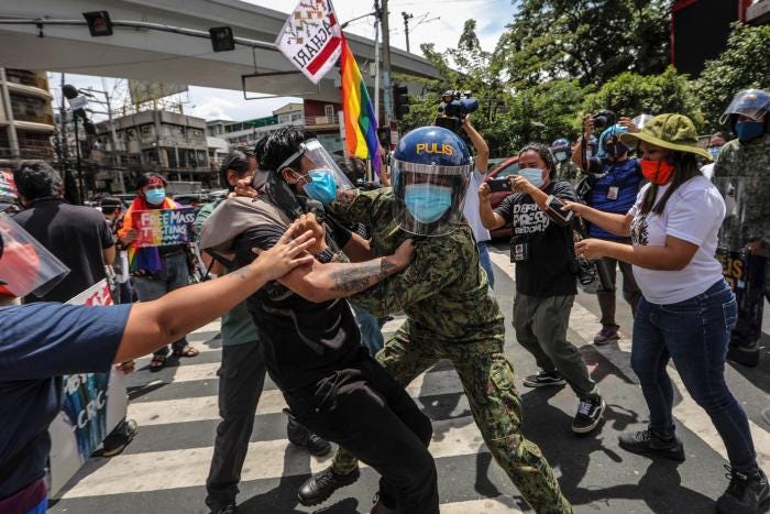 Police arrest protesters during a Pride march in Manila, Philippines, June 26, 2020. Police arrest protesters during a Pride march in Manila, Philippines, June 26, 2020.
