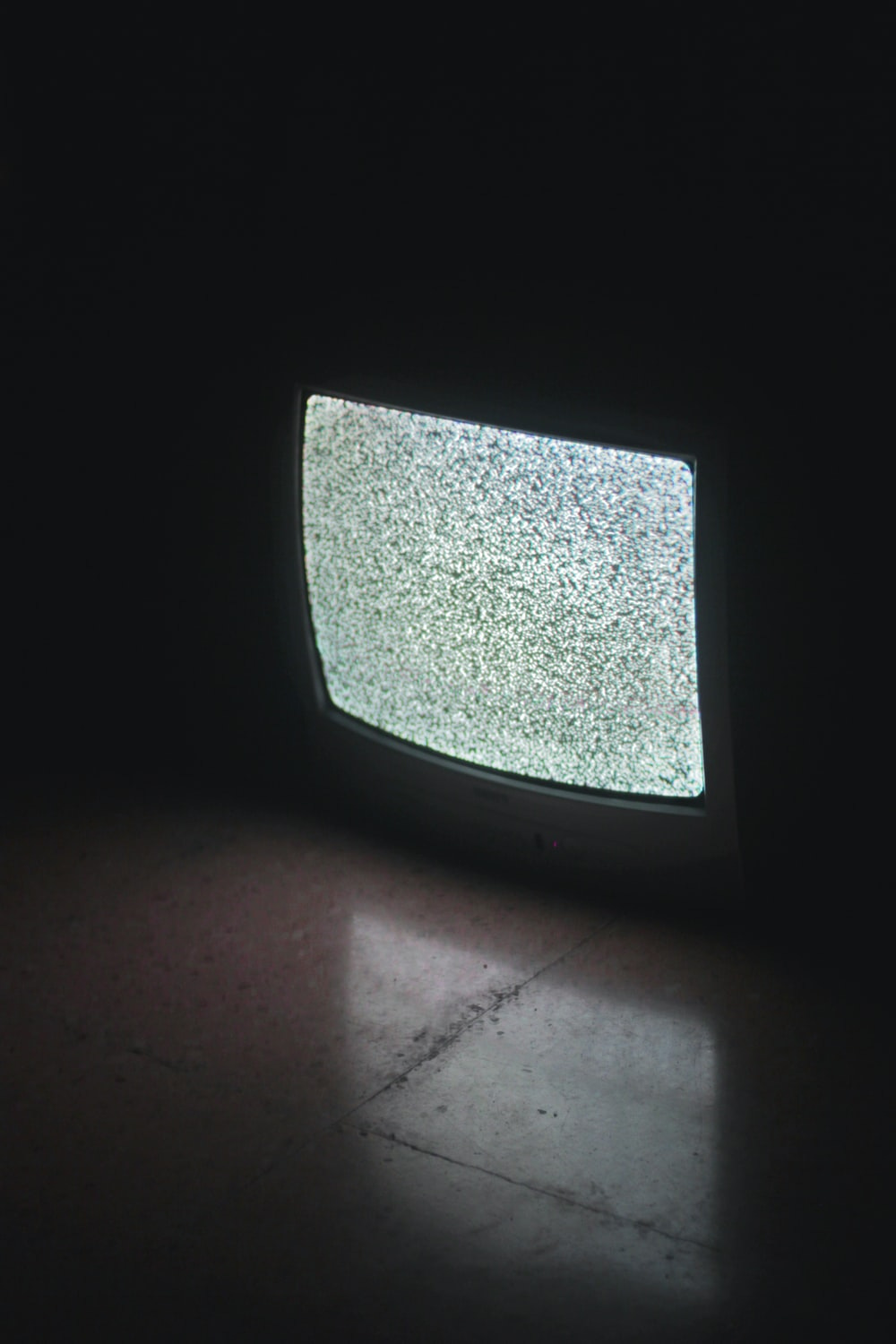 gray crt tv turned on in a dark room gray crt tv turned on in a dark room