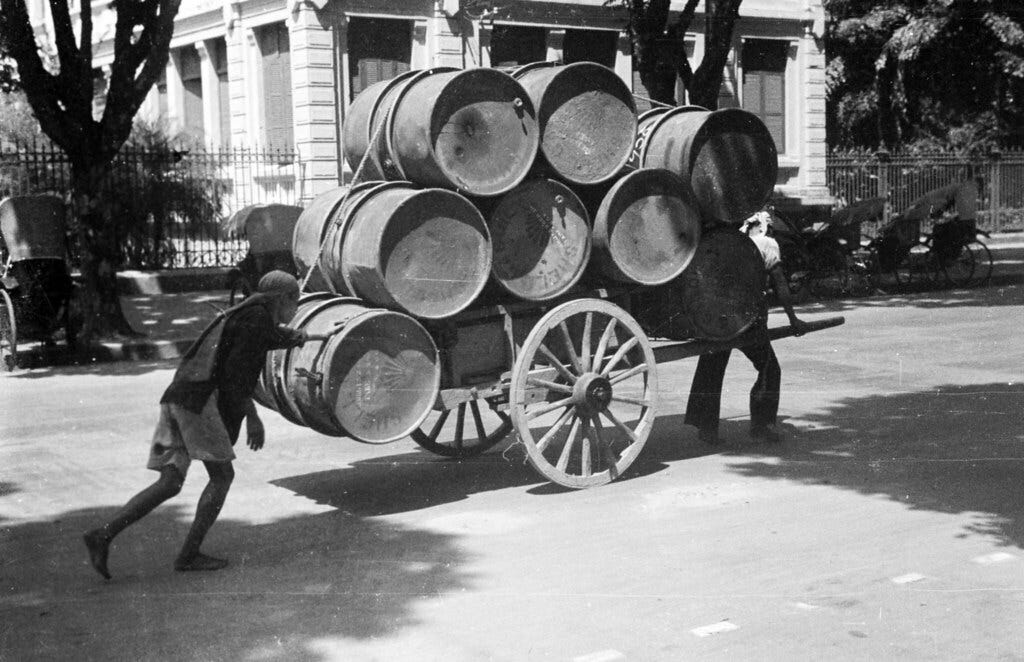 HANOI 1940 - Carting petroleum barrels through city street HANOI 1940 - Carting petroleum barrels through city street