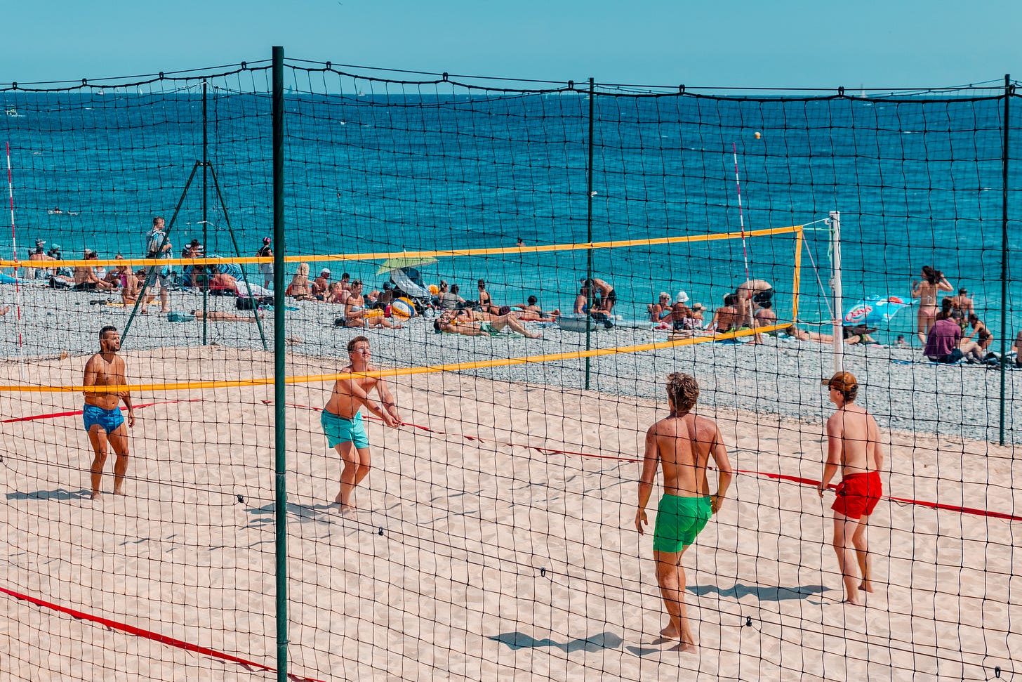 Men playing beach volleyball in Cote D’Azur: A photo by David Elikwu