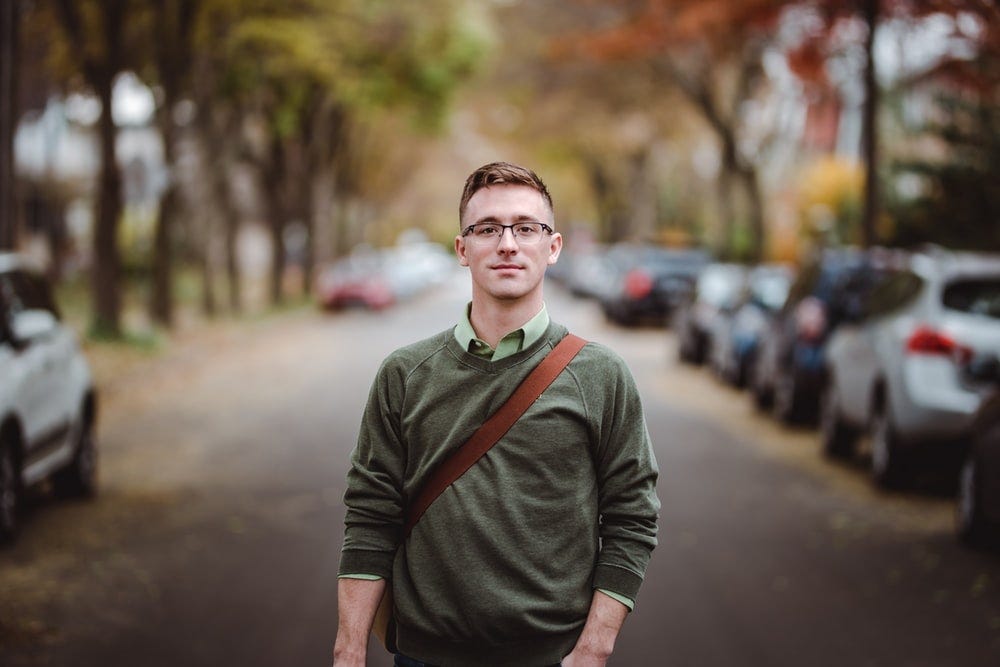 man standing on road