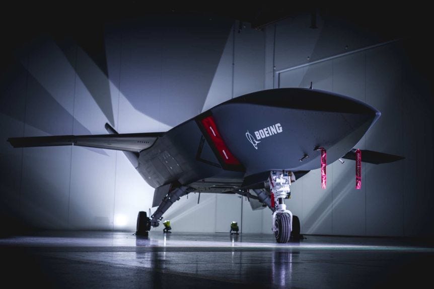 A large jet-like drone in a hangar.