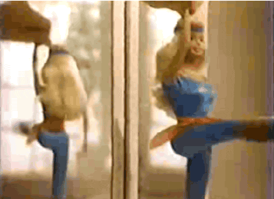 A Barbie doll has one leg lifted as a hand spins her in place [gif]
