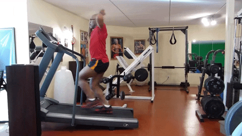 a man engages his core as he perfectly vogue dances while walking on a treadmill [gif]