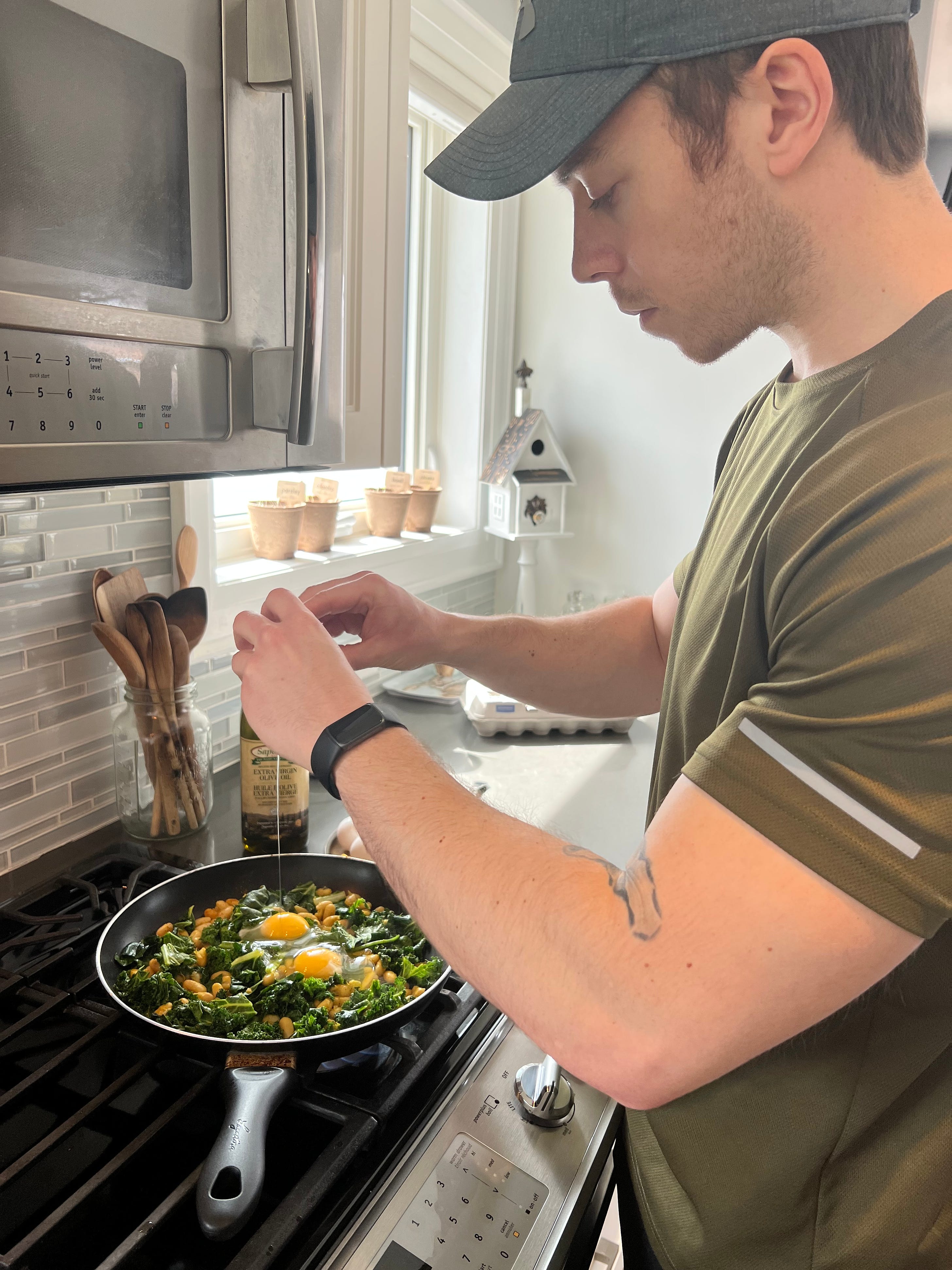 Cooking my slow carb diet lunch (white kidney beans, eggs, tuna, spinach, kale, swiss chard, olive oil, and a variety of spices). March 22, 2022.