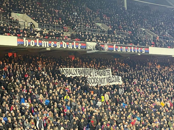 Banner held up in the Lower Holmesdale Block E by the Holmesdale Fanatics reading: "MORALLY BANKRUPT PARASITES, SOCIOS NOT WELCOME"