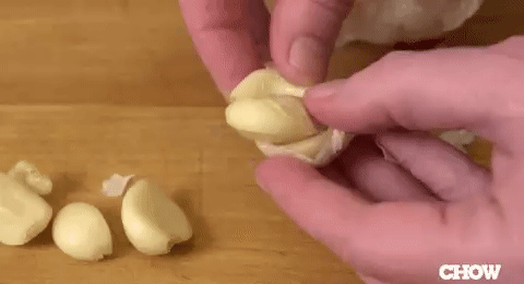 Popping out raw garlic straight from the clove.